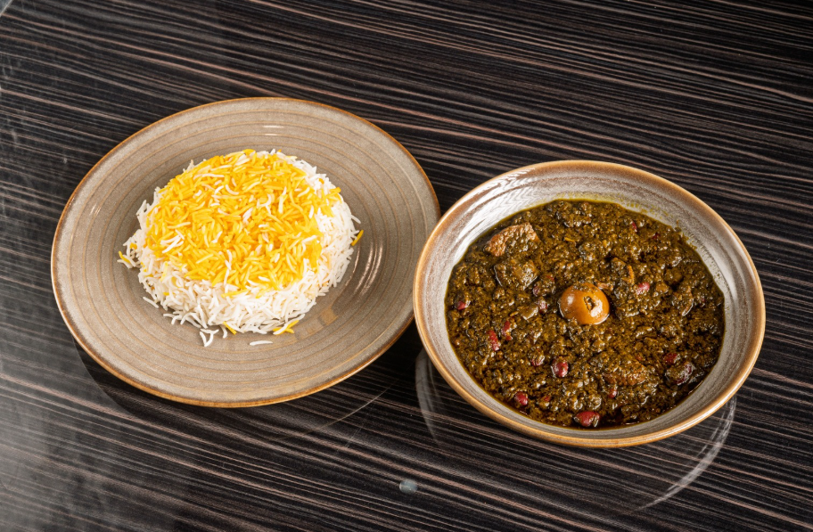 Persian Tahdig paired with Ghormeh Sabzi stew for authentic dining experience